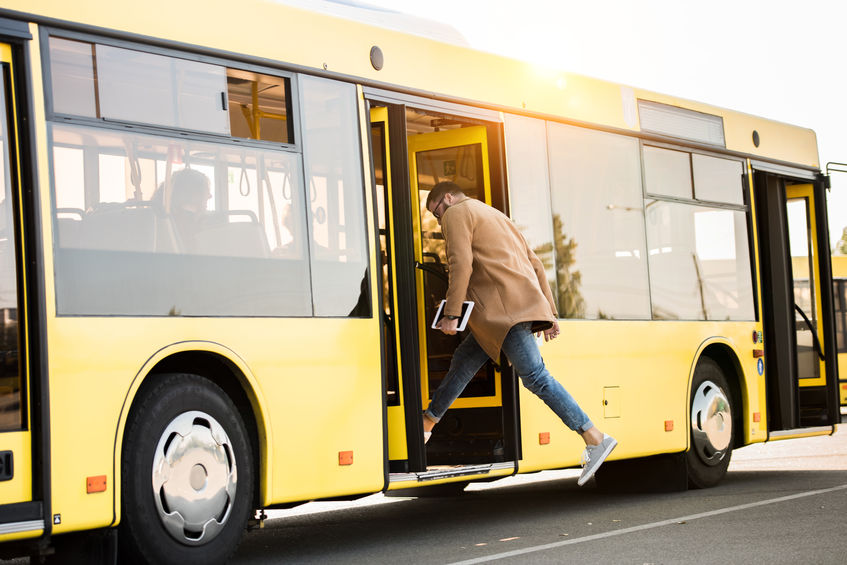 Man Boarding a Bus