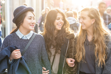 Three Young Women on a Sidewalk