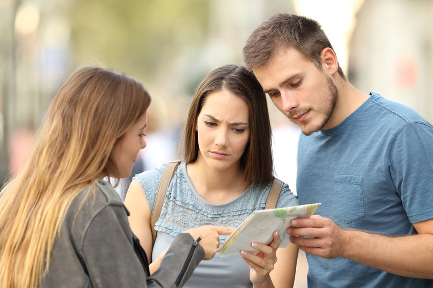 Woman Helping Couple with Directions